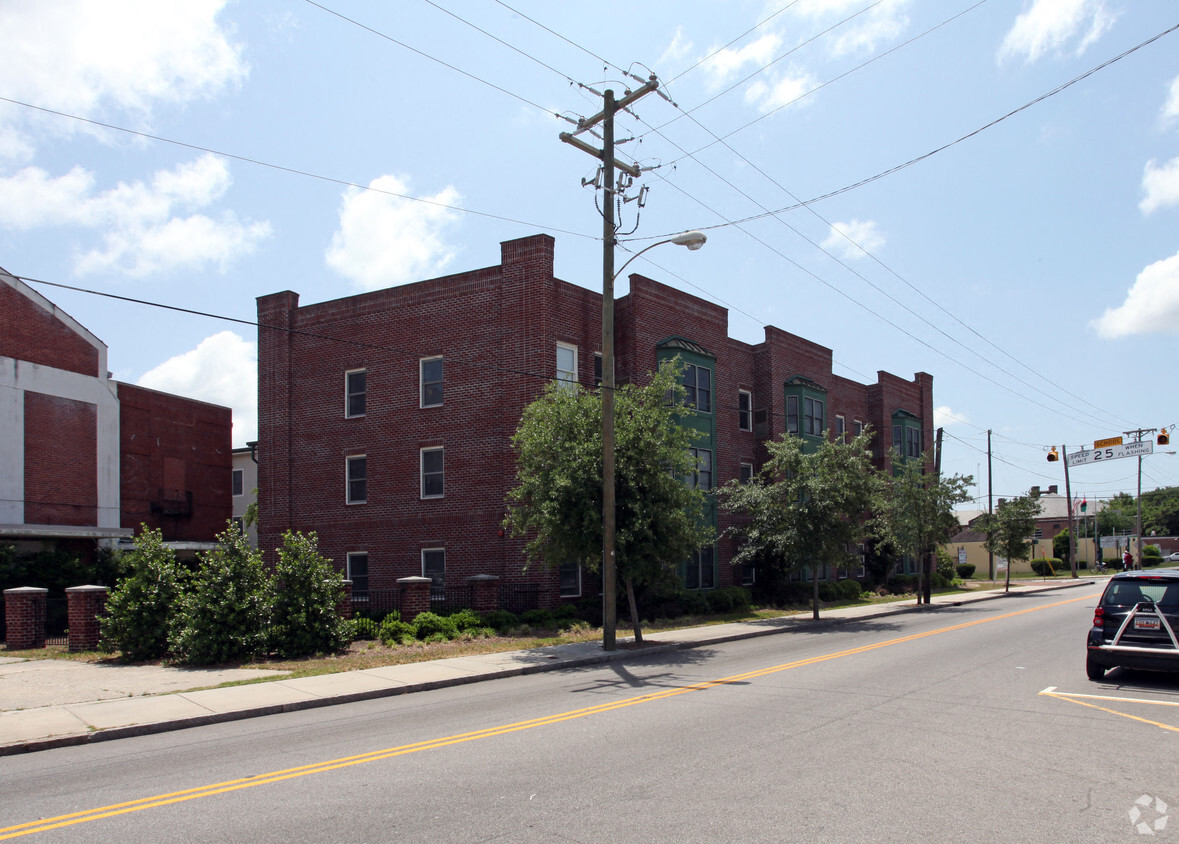 a red brick building on the corner of a city street